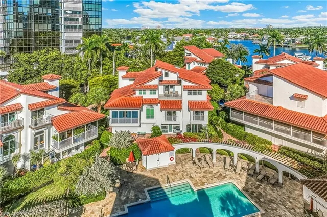 an aerial view of multiple houses with a yard