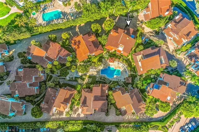 an aerial view of residential houses with outdoor space and street view