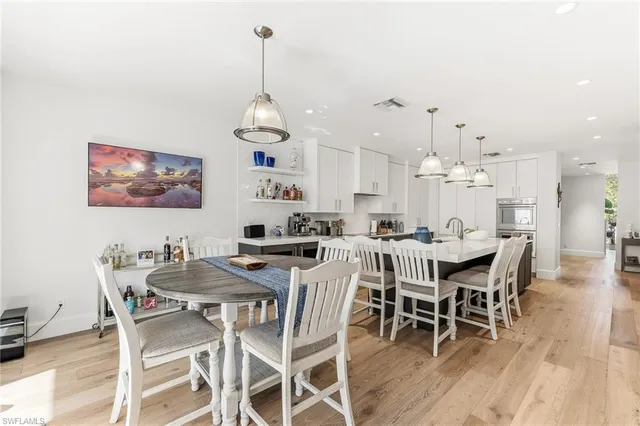 a dining room with furniture a rug and wooden floor