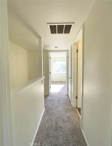 a view of a hallway with a white walls