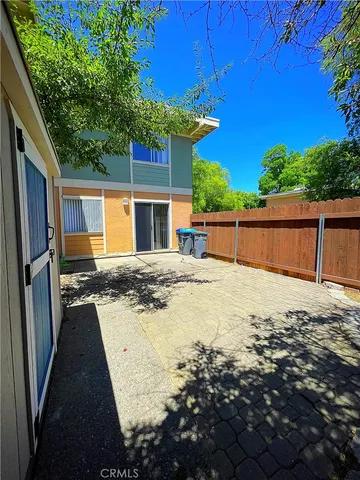 a view of a house with backyard and sitting area