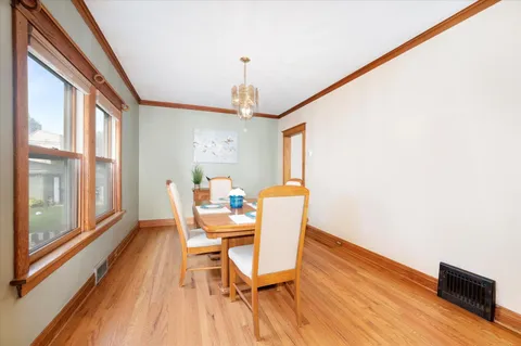 a dining room with furniture and wooden floor