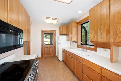 a large kitchen with a sink and washing machine