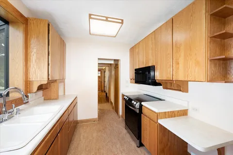 a kitchen with stainless steel appliances a stove sink and cabinets
