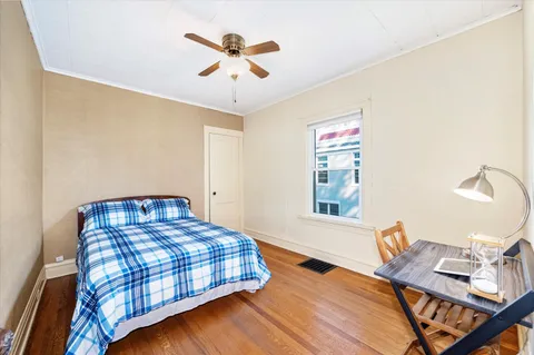 a bedroom with a bed and a chandelier
