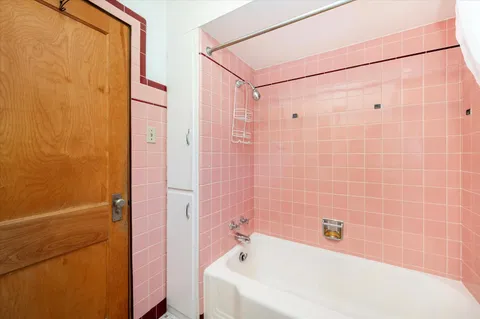 a bathroom with a bathtub and a shower