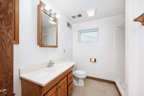 a white toilet sitting next to a bathroom sink