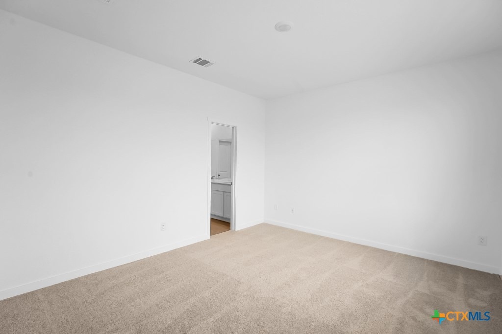 247 Flathead New Braunfels, TX 78130 - Photo 13 of 17 Unfurnished bedroom featuring light colored carpet and ensuite bath