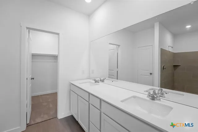 a bathroom with a double vanity sink and a mirror