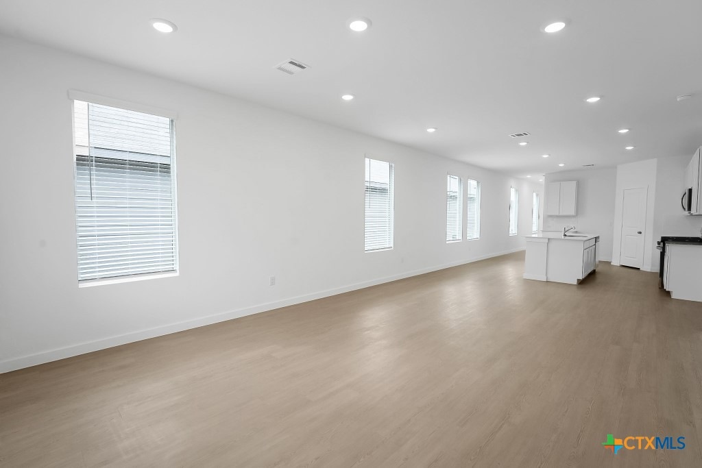 247 Flathead New Braunfels, TX 78130 - Photo 3 of 17 Unfurnished living room with recessed lighting and light wood-style floors