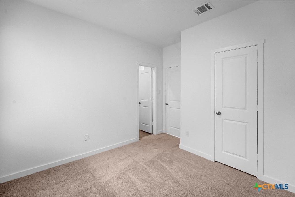247 Flathead New Braunfels, TX 78130 - Photo 8 of 17 Unfurnished bedroom featuring baseboards and light carpet