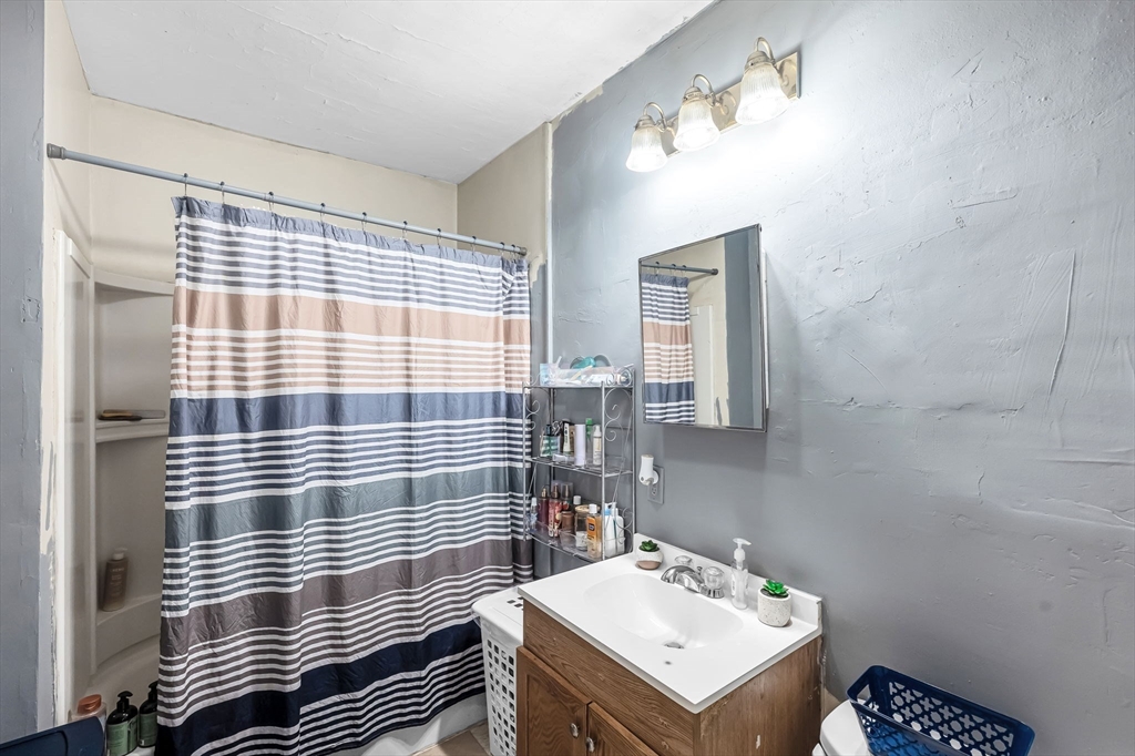 123-125 Ranney Street Springfield, MA 01108 - Photo 12 of 26 a bathroom with a sink toilet and mirror