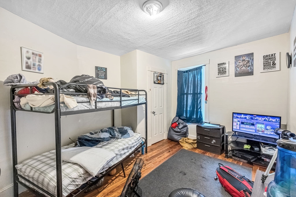 123-125 Ranney Street Springfield, MA 01108 - Photo 13 of 26 a bedroom with a bed and a tv