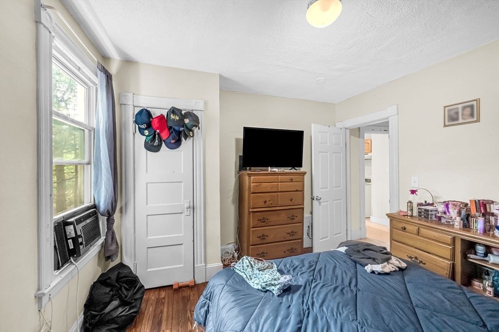 123-125 Ranney Street Springfield, MA 01108 - Photo 17 of 26 a bedroom with a bed and a flat tv screen