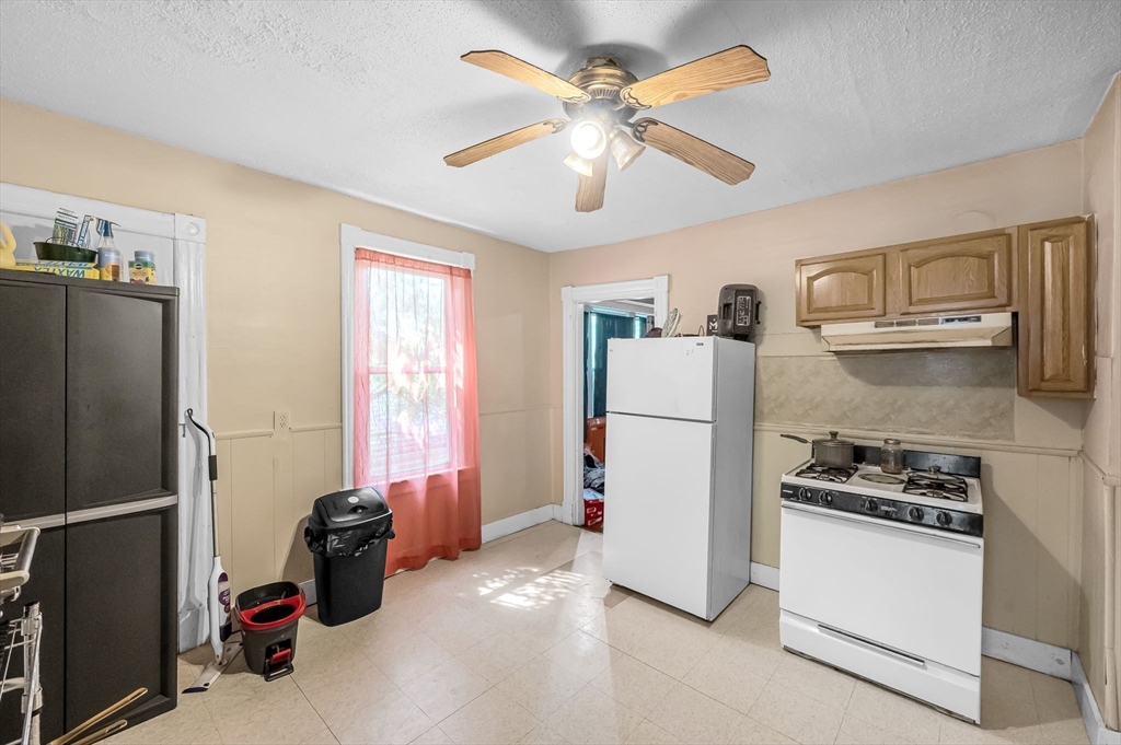 123-125 Ranney Street Springfield, MA 01108 - Photo 19 of 26 a kitchen with stainless steel appliances a refrigerator and a stove top oven