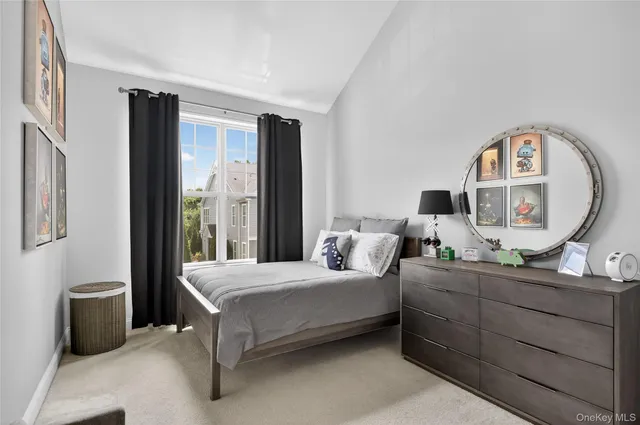 a bedroom with a bed and a mirror