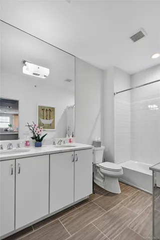 a bathroom with a sink toilet and a mirror