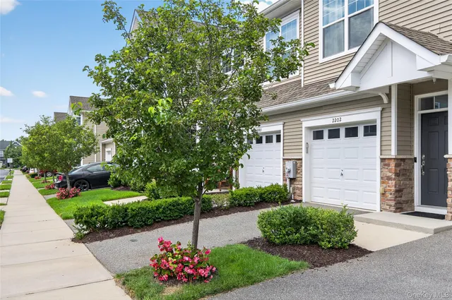 a front view of a house with a garden