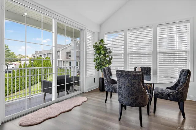 a view of a dining room with furniture and a potted plant