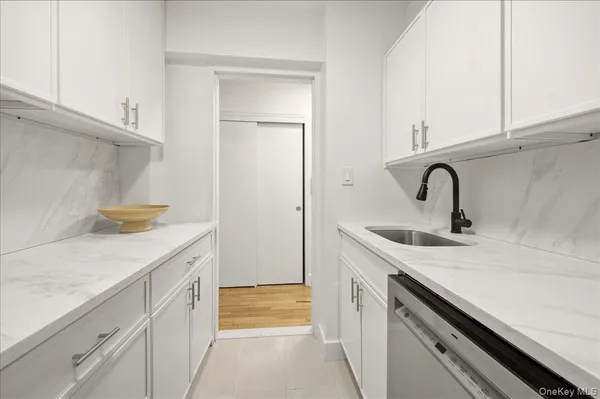 a kitchen with a sink and cabinets