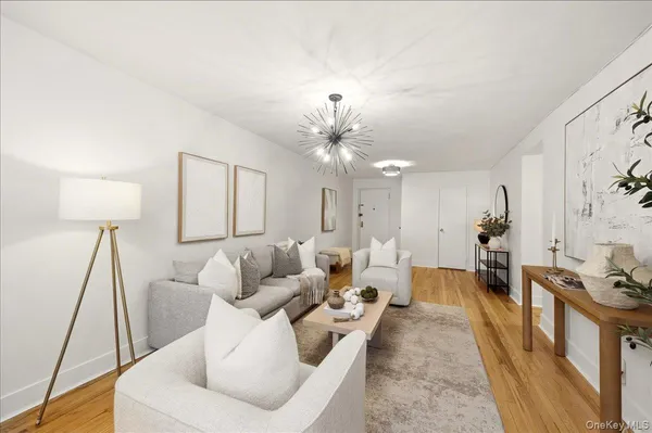 a living room with furniture and a chandelier
