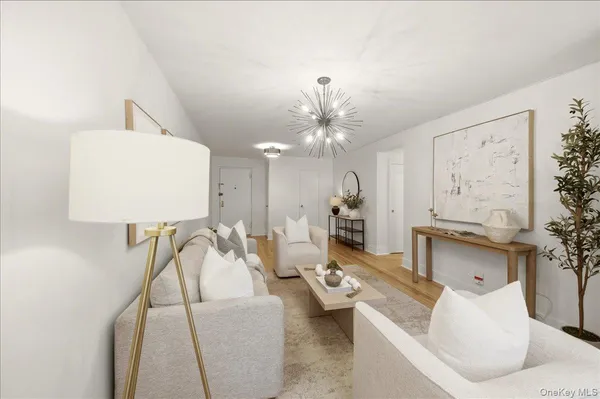 a living room with furniture and a chandelier