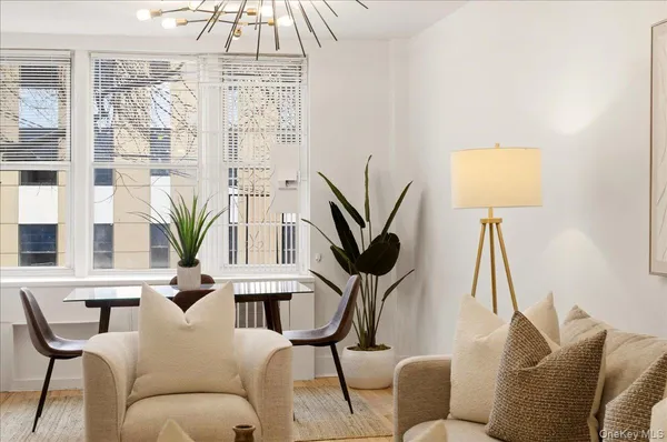 a living room with furniture a window and a chandelier