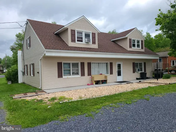 a front view of a house with a yard and porch