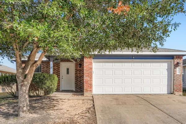 front view of a house with a tree