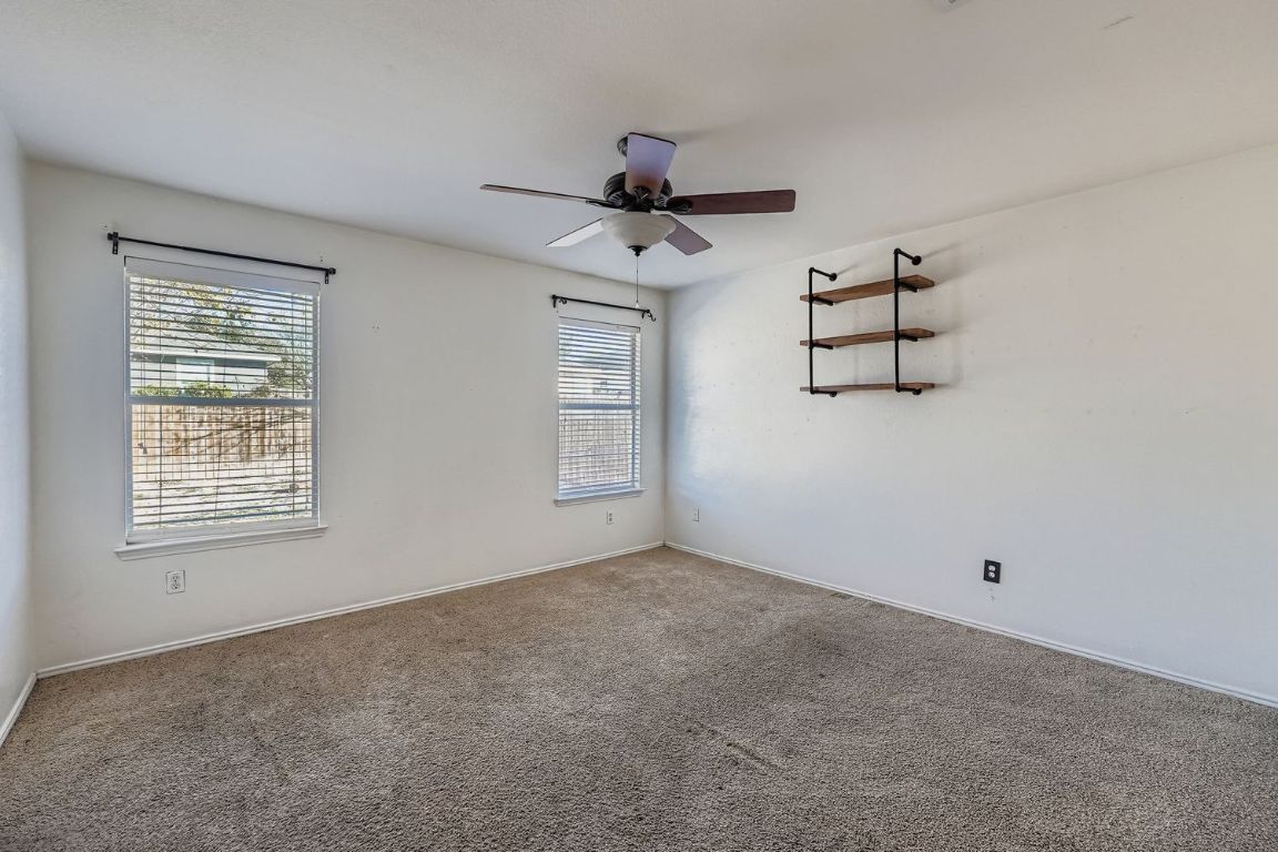 200 Firebush Way Buda, TX 78610 - Photo 17 of 29 a view of room with ceiling fan and windows