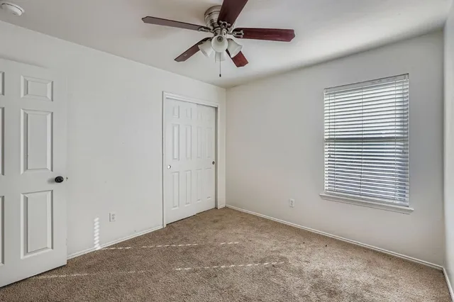 a view of a livingroom with a ceiling fan and window