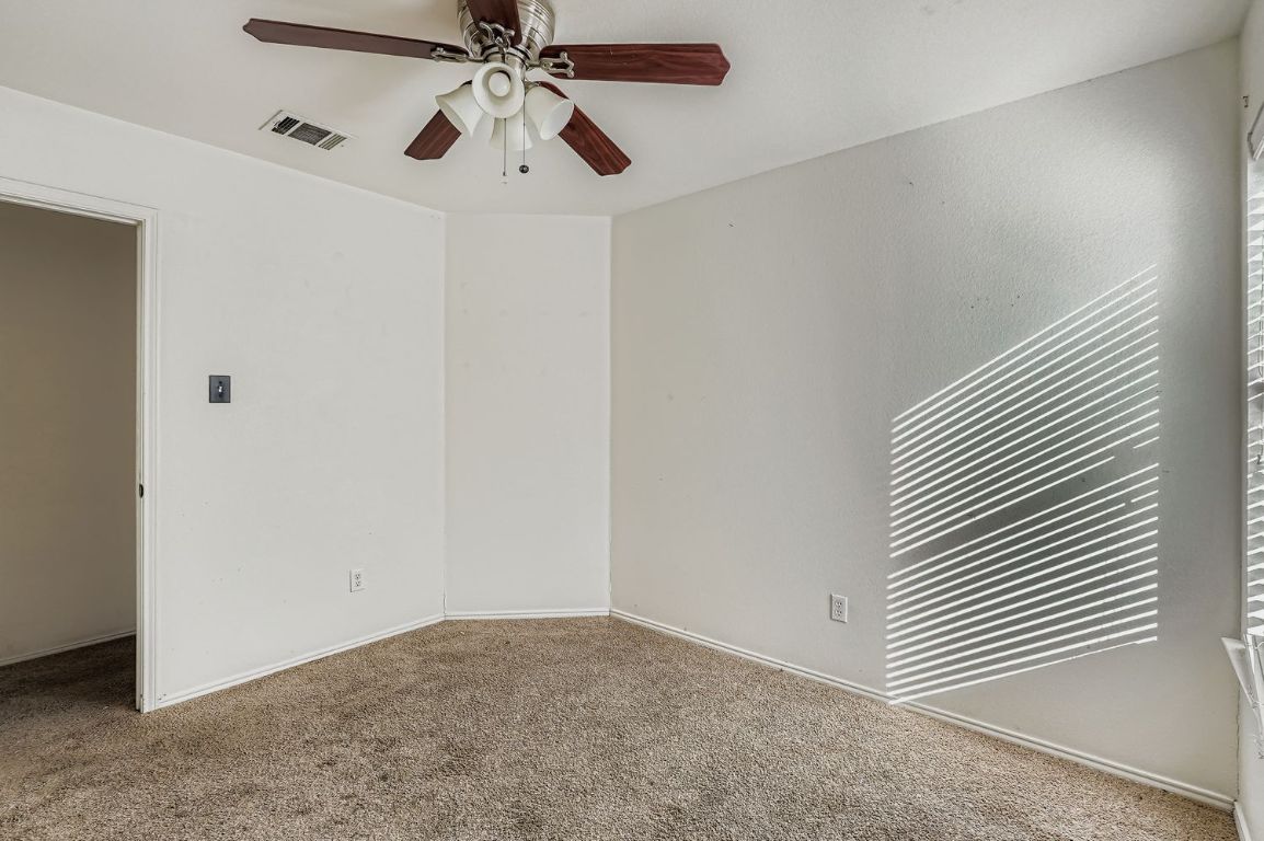 200 Firebush Way Buda, TX 78610 - Photo 24 of 29 an empty room with windows and fan