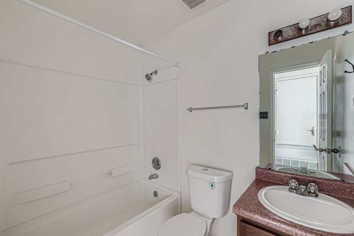 200 Firebush Way Buda, TX 78610 - Photo 25 of 29 a bathroom with a sink a toilet and a bathtub