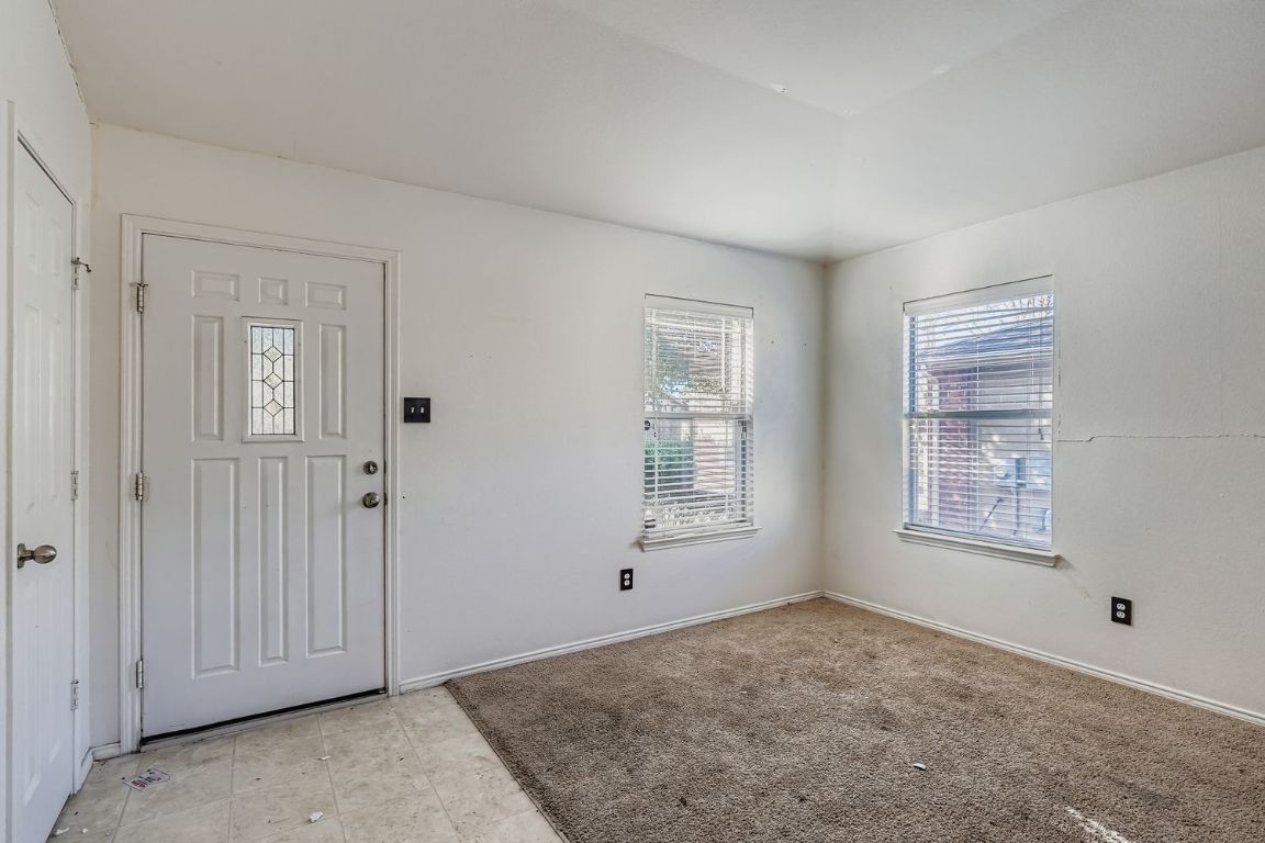 200 Firebush Way Buda, TX 78610 - Photo 4 of 29 an empty room with windows