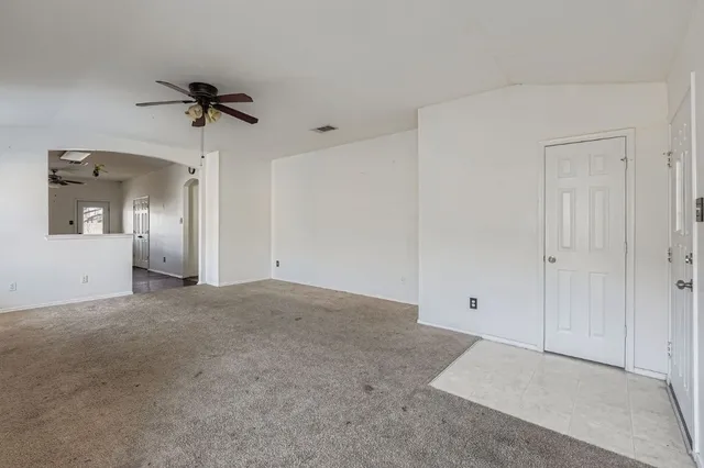 a view of a big room with closet and chandelier fan