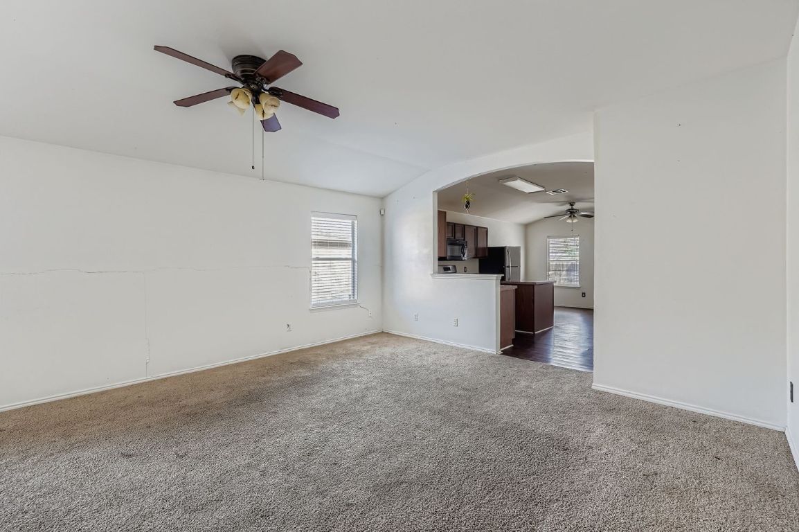 200 Firebush Way Buda, TX 78610 - Photo 10 of 29 a view of a livingroom with a kitchen stove a sink and a refrigerator
