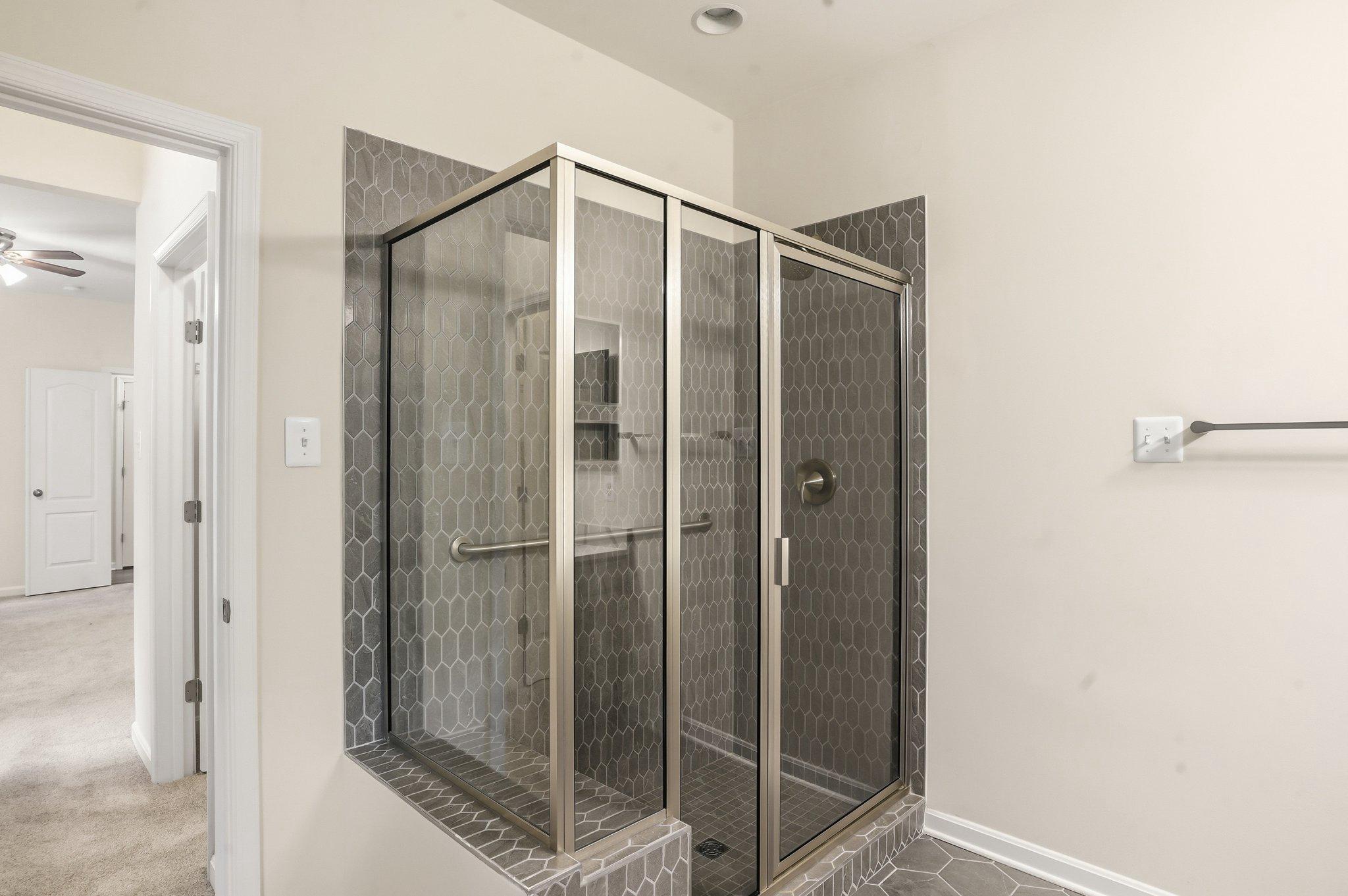 4755 South Polling House Road Harwood, MD 20776 - Photo 26 of 36 Sleek modern primary shower with elegant tiles.