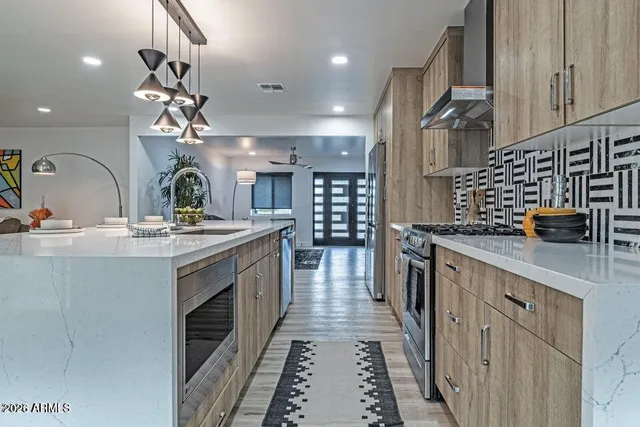 a kitchen with sink a stove and cabinets