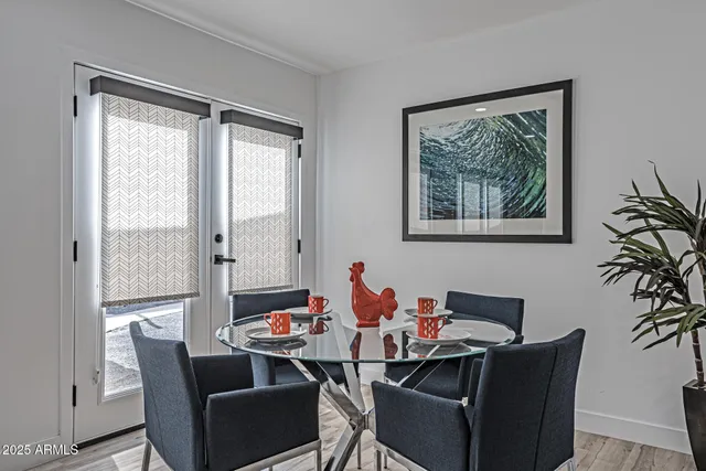 a living room with furniture and painting on the wall