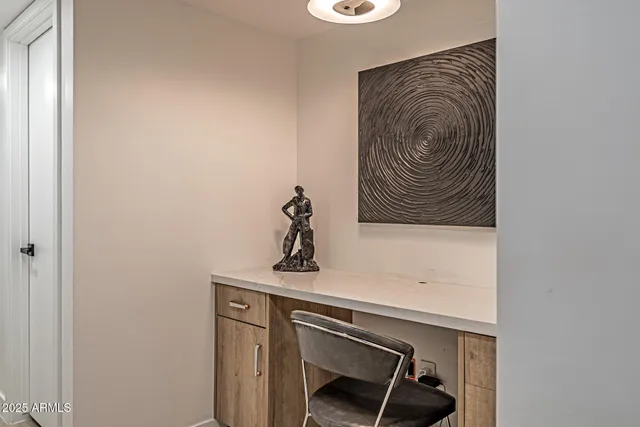 a view of hallway with stainless steel appliances wooden floor