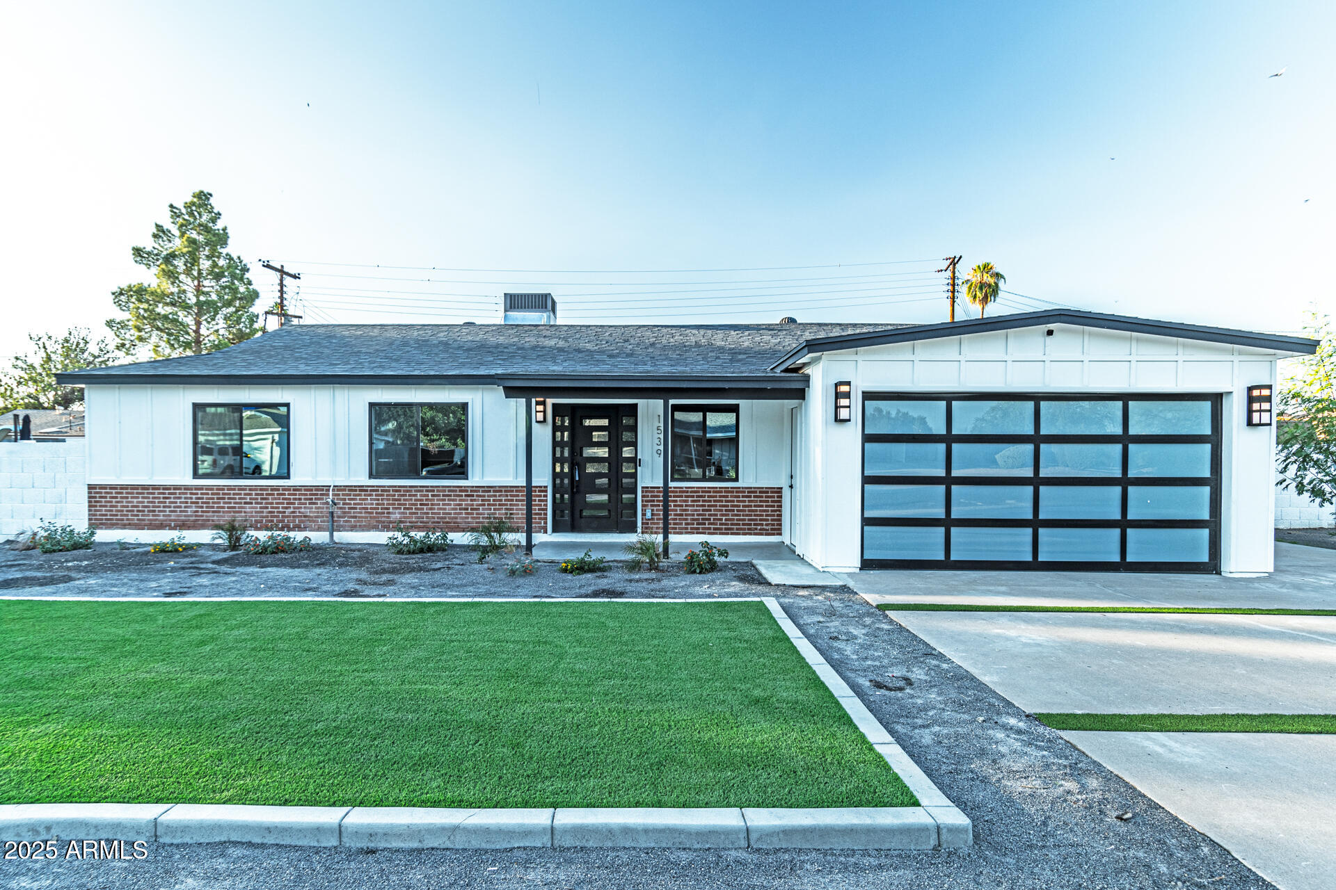 1539 West Puget Avenue Phoenix, AZ 85021 - Photo 2 of 29 a front view of a house with a yard and garage