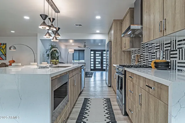 a kitchen with sink a stove and cabinets