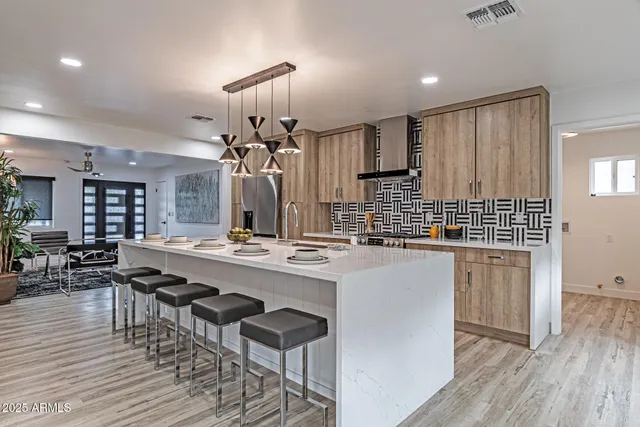a large kitchen with a table and chairs