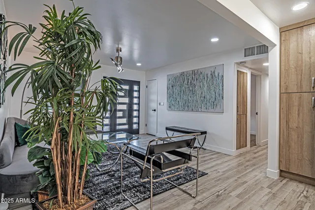 a living room with furniture and a potted plant