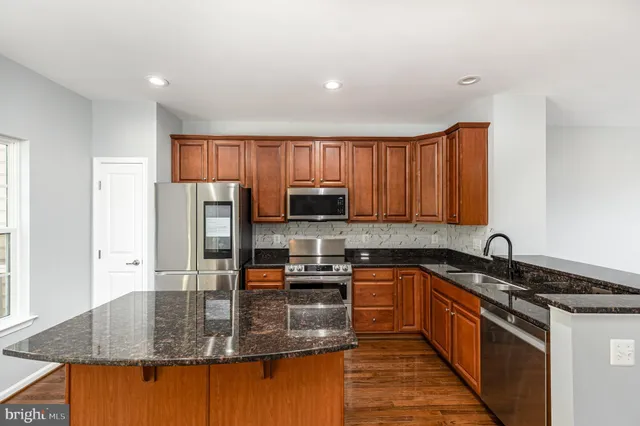 a kitchen with stainless steel appliances granite countertop a granite counter tops and a stove