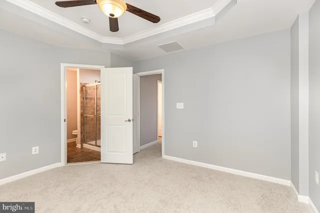 an empty room with chandelier fan