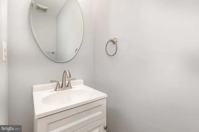a bathroom with a sink and mirror
