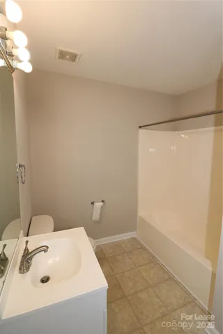 a bathroom with a sink and vanity