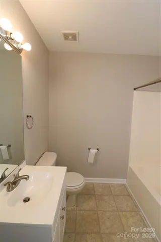 a bathroom with a sink a toilet and vanity