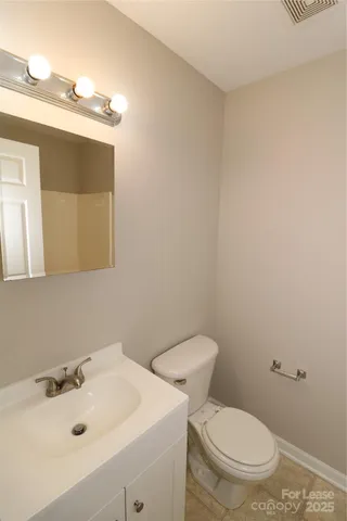 a bathroom with a sink a toilet and mirror